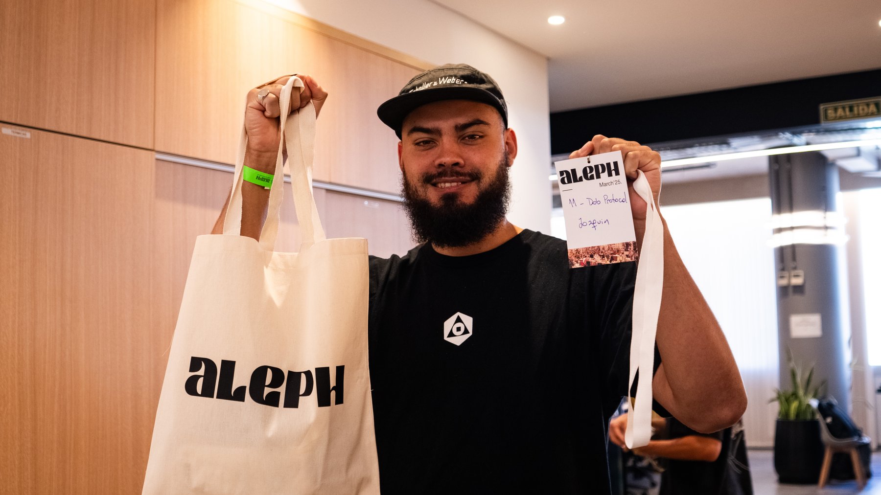 A builder with their Aleph March '25 badge
