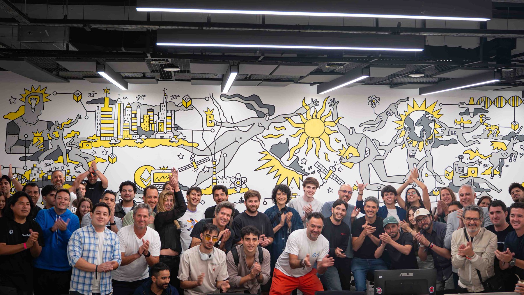 The Aleph March '26 community in front of the Hub's mural